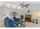 Cozy living room featuring a ceiling fan and a large television set at 17229 N 51St Dr, Glendale, AZ 85308