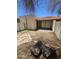 View of the backyard featuring desert landscaping, a covered patio and stone pavers at 189 Laguna E Dr, Litchfield Park, AZ 85340