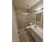 Clean bathroom with tile floor, vanity, and walk-in shower at 189 Laguna E Dr, Litchfield Park, AZ 85340