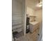 Convenient laundry room equipped with washer, dryer, shelving, and a hot water tank at 189 Laguna E Dr, Litchfield Park, AZ 85340