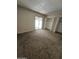 Bedroom features carpet and access to patio with dual closets at 189 Laguna E Dr, Litchfield Park, AZ 85340