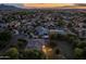 Aerial view of neighborhood homes at twilight; a home with outdoor string lights can be seen in the foreground at 21228 E Excelsior Ave, Queen Creek, AZ 85142