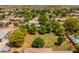 Expansive aerial view of a beautifully landscaped property featuring lush greenery and a well-maintained lawn at 21228 E Excelsior Ave, Queen Creek, AZ 85142