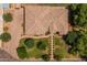 Overhead shot of a large home with tile roof, mature trees, brick driveway, and meticulous landscaping at 21228 E Excelsior Ave, Queen Creek, AZ 85142