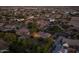 Aerial view of a single Gathering home with string lights in the backyard in a well manicured neighborhood at 21228 E Excelsior Ave, Queen Creek, AZ 85142