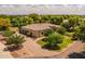 Aerial shot of a lovely home with a large driveway and mature trees in a serene setting at 21228 E Excelsior Ave, Queen Creek, AZ 85142