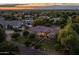 Aerial view of a home with mature trees in the front yard at dusk at 21228 E Excelsior Ave, Queen Creek, AZ 85142