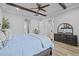 Bedroom showing exposed beam ceiling, ensuite access, wood floors, and a cool color palette at 21228 E Excelsior Ave, Queen Creek, AZ 85142