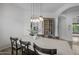 Dining room featuring a white table with black chairs, modern lighting, and decor at 21228 E Excelsior Ave, Queen Creek, AZ 85142