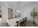 A bright dining room with wood-look flooring, rustic cabinet and view to other rooms at 21228 E Excelsior Ave, Queen Creek, AZ 85142