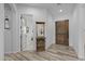 Entryway with decorative mirror and view into additional room with wooden doorway at 21228 E Excelsior Ave, Queen Creek, AZ 85142