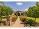 Charming home exterior with stone accents, a well-manicured lawn, and a welcoming walkway at 21228 E Excelsior Ave, Queen Creek, AZ 85142