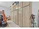 Garage with a large wall of cabinets for storing and organizing, plus door to the interior of the home at 21228 E Excelsior Ave, Queen Creek, AZ 85142
