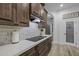 Stylish kitchen featuring dark wood cabinetry, white countertops, and stainless steel appliances at 21228 E Excelsior Ave, Queen Creek, AZ 85142