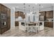 Kitchen with dark wood cabinets, a white island with seating, and stainless steel appliances at 21228 E Excelsior Ave, Queen Creek, AZ 85142