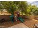 Backyard play area with wood chips, and a fun, wooden playset for to enjoy at 21228 E Excelsior Ave, Queen Creek, AZ 85142