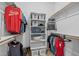 Efficient walk-in closet with tiered storage, hanging rods, and shelving for optimal wardrobe organization at 21228 E Excelsior Ave, Queen Creek, AZ 85142