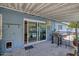 Covered back patio with a grill, sliding glass doors to the pool, and easy outdoor access at 2335 W Campus Dr, Phoenix, AZ 85015
