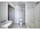 Bathroom featuring a pedestal sink, tile floor, and a tub with shower at 2335 W Campus Dr, Phoenix, AZ 85015