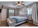 A primary bedroom features two windows, ceiling fan, and a large bed with white headboard at 2335 W Campus Dr, Phoenix, AZ 85015