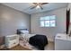 Cozy bedroom with neutral walls, ceiling fan, and a twin bed at 2335 W Campus Dr, Phoenix, AZ 85015