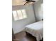 Simple bedroom with a single bed, ample natural light, and neutral wall color at 2335 W Campus Dr, Phoenix, AZ 85015