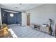 Bonus room with a blue accent wall, gray walls, tile floor, and a convenient storage cabinet at 2335 W Campus Dr, Phoenix, AZ 85015