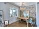 Cozy dining area with accent wall, chandelier, and natural light at 2335 W Campus Dr, Phoenix, AZ 85015