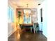 Bright dining room featuring a modern light fixture, exposed brick wall, and sleek flooring at 2335 W Campus Dr, Phoenix, AZ 85015
