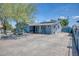 Charming exterior of home with unique blue paint, desert landscaping, and solar panels at 2335 W Campus Dr, Phoenix, AZ 85015
