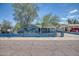 Charming light blue exterior with a tidy front yard and secure decorative metal and concrete fence at 2335 W Campus Dr, Phoenix, AZ 85015