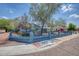 Charming single-story home with a block fence, mature trees, and well-kept landscaping at 2335 W Campus Dr, Phoenix, AZ 85015