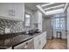 Well-lit kitchen featuring stainless steel appliances, neutral tiling, and under cabinet lighting at 2335 W Campus Dr, Phoenix, AZ 85015