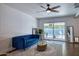 Bright living room with stylish blue sofa, leading to a pool view through sliding glass doors at 2335 W Campus Dr, Phoenix, AZ 85015
