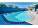 Sparkling in-ground pool with a brick border, surrounded by a concrete patio and privacy fence at 2335 W Campus Dr, Phoenix, AZ 85015