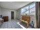 Bright sun room featuring tile floors, a large window, and a wooden bench at 2335 W Campus Dr, Phoenix, AZ 85015