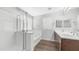Bright bathroom featuring a soaking tub, walk-in shower, and wood-look flooring at 2668 N 73Rd Gln, Phoenix, AZ 85035