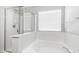 Close-up view of bathroom's tub and shower space, with sleek, modern fixtures at 2668 N 73Rd Gln, Phoenix, AZ 85035
