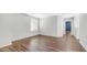Bright bedroom featuring neutral walls, wood flooring, and a large window with blinds at 2668 N 73Rd Gln, Phoenix, AZ 85035