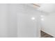 Walk-in closet featuring white walls, wood floors, and built-in shelving for optimal storage at 2668 N 73Rd Gln, Phoenix, AZ 85035