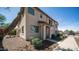 Inviting two-story home with a covered entry, desert landscaping, and a well-lit walkway at 2668 N 73Rd Gln, Phoenix, AZ 85035