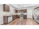 This kitchen features stainless steel appliances, dark cabinets, and a convenient layout for cooking at 2668 N 73Rd Gln, Phoenix, AZ 85035