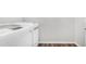 Modern laundry room featuring a white washer and dryer set and wood-look flooring at 2668 N 73Rd Gln, Phoenix, AZ 85035