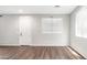 A bright, open-concept living area with hardwood flooring, neutral paint, and abundant natural light at 2668 N 73Rd Gln, Phoenix, AZ 85035