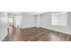 Spacious living room with wood flooring, neutral walls, and natural light through blinds at 2668 N 73Rd Gln, Phoenix, AZ 85035