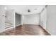 A bright living room with modern floors, neutral walls, and a staircase leading to the upper level at 2668 N 73Rd Gln, Phoenix, AZ 85035