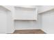 Spacious walk-in closet with wood floor and ample rod space for optimal storage at 2668 N 73Rd Gln, Phoenix, AZ 85035