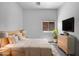 Modern bedroom featuring a platform bed, nightstands, a TV and desert views at 2971 N Rosewood Ave, Casa Grande, AZ 85122