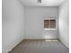 Neutral empty bedroom with tan carpet, gray walls and a bright backyard view at 2971 N Rosewood Ave, Casa Grande, AZ 85122