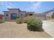 Single-story home with a three-car garage, neutral stucco, tile roof, and drought-tolerant landscaping at 2971 N Rosewood Ave, Casa Grande, AZ 85122